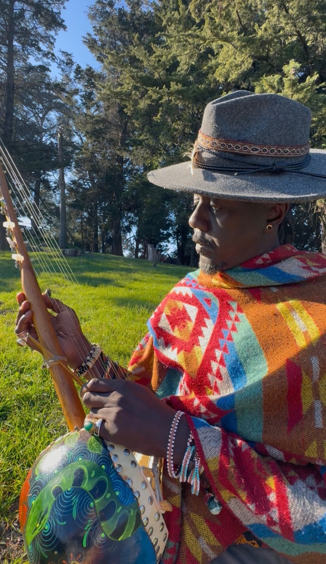 AshEL playing ngoni in poncho